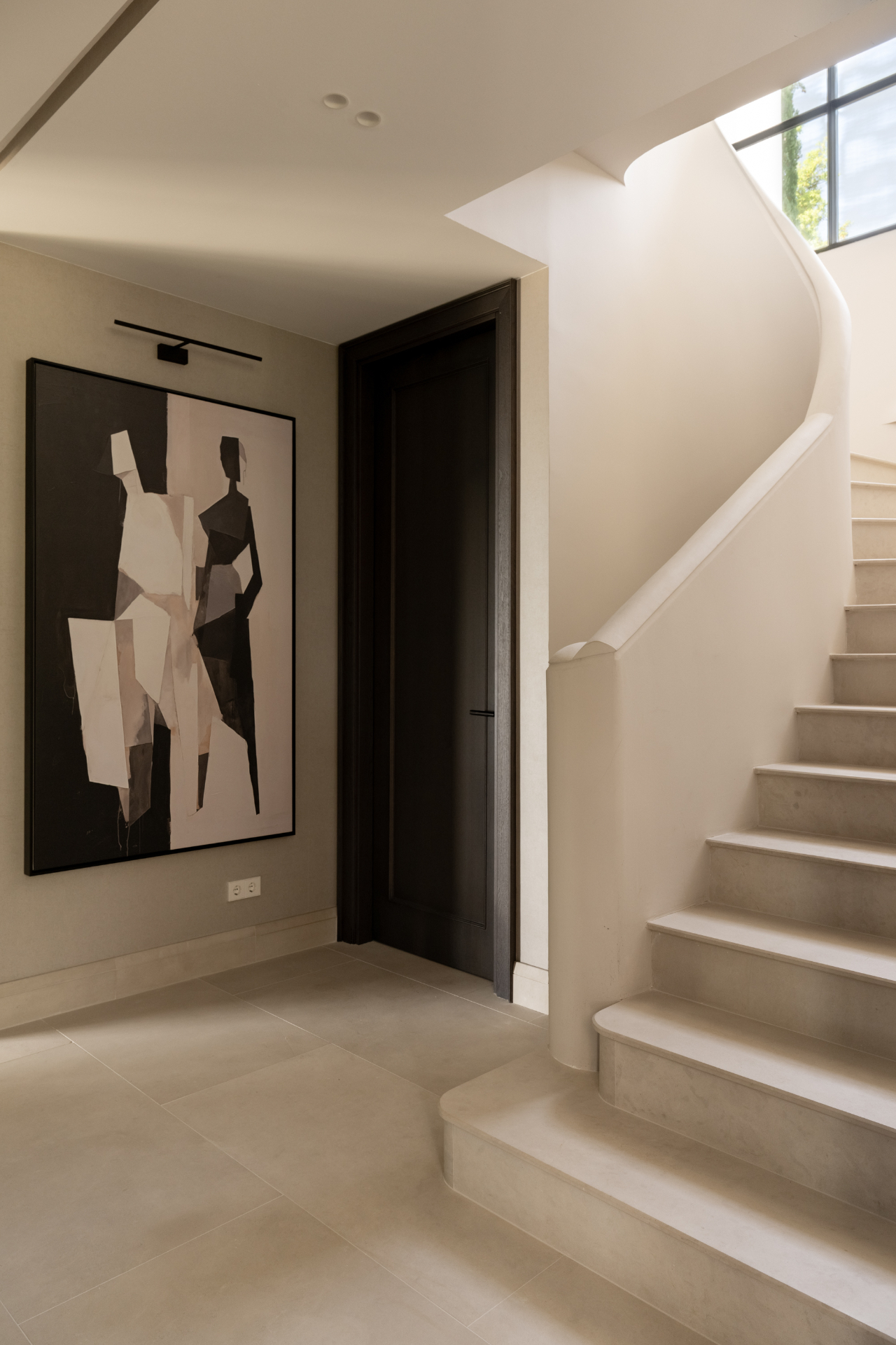 A curving landing with abstract artwork at Casa Servetta.